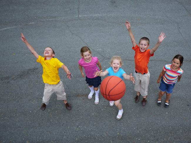 Image of happy friends playing basketball on sports ground. For story about kids not being able to bring balls to school at Dorset Primary School. Picture: iStock