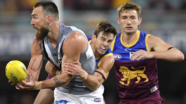 Charlie Dixon is tackled during the Power’s loss to Brisbane. Picture: Albert Perez/Getty