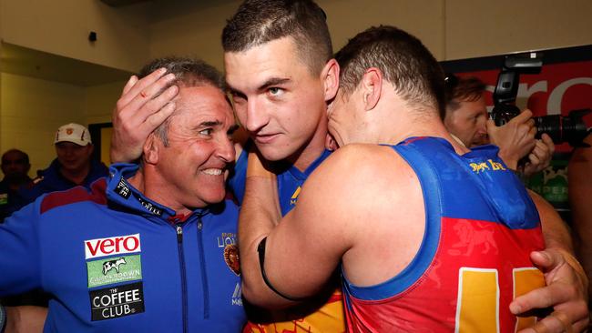 Lions coach Chris Fagan with Tom Rockliff and Dayne Zorko.