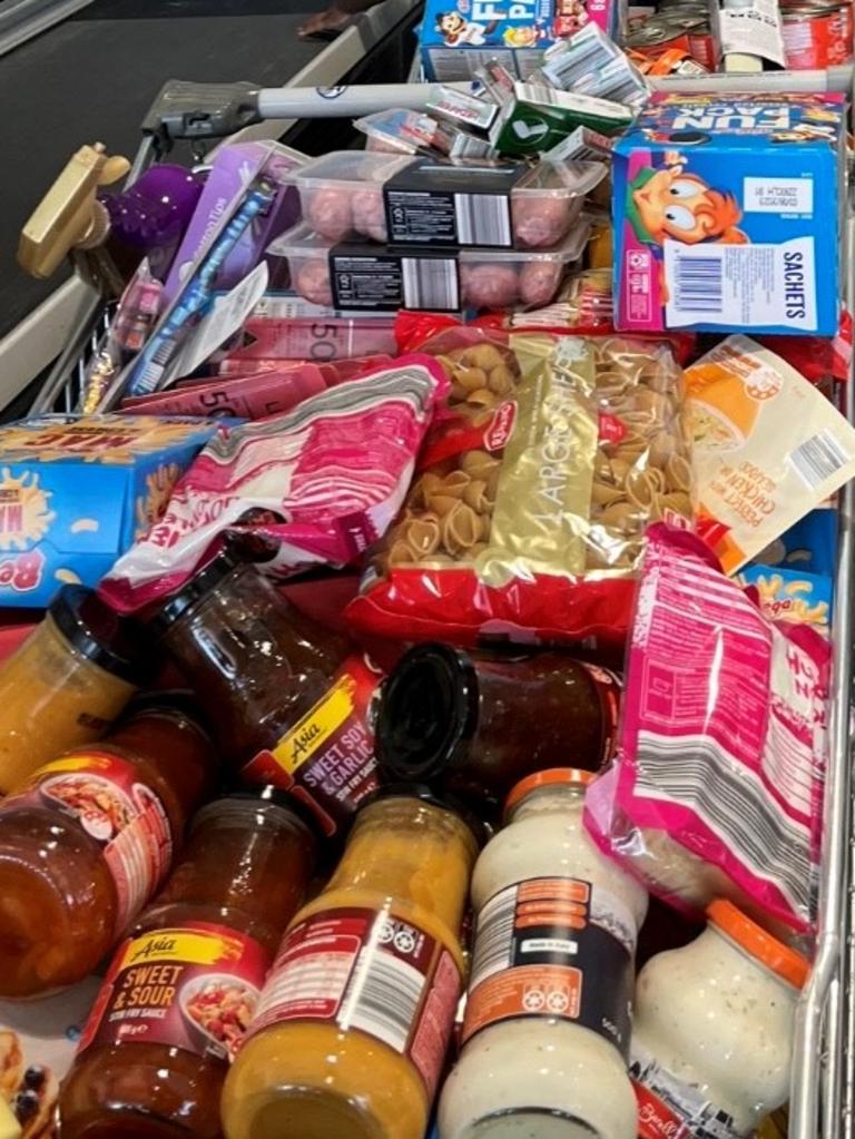 The family’s haul features seven packets of spaghetti, two boxes of mini cereal packets, meatballs and sauces.