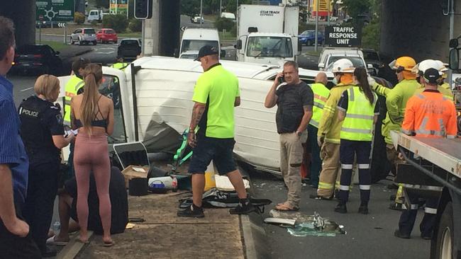 Emergency services and bystanders at the crash site. Picture: Dominique Hampson