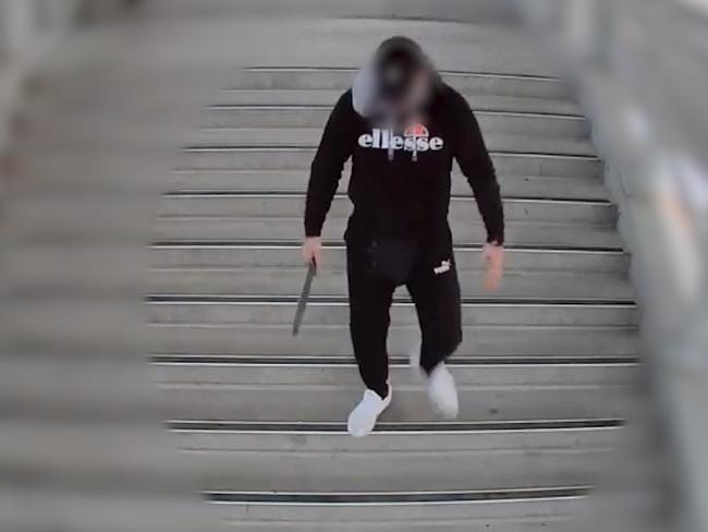 Friday 12 June 2020: CCTV footage of a young male armed with a machete walking on to the platform at Rooty Hill station in front of terrified commuters before being confronted by four teenage males armed with knives and a hammer. Picture: NSW Police