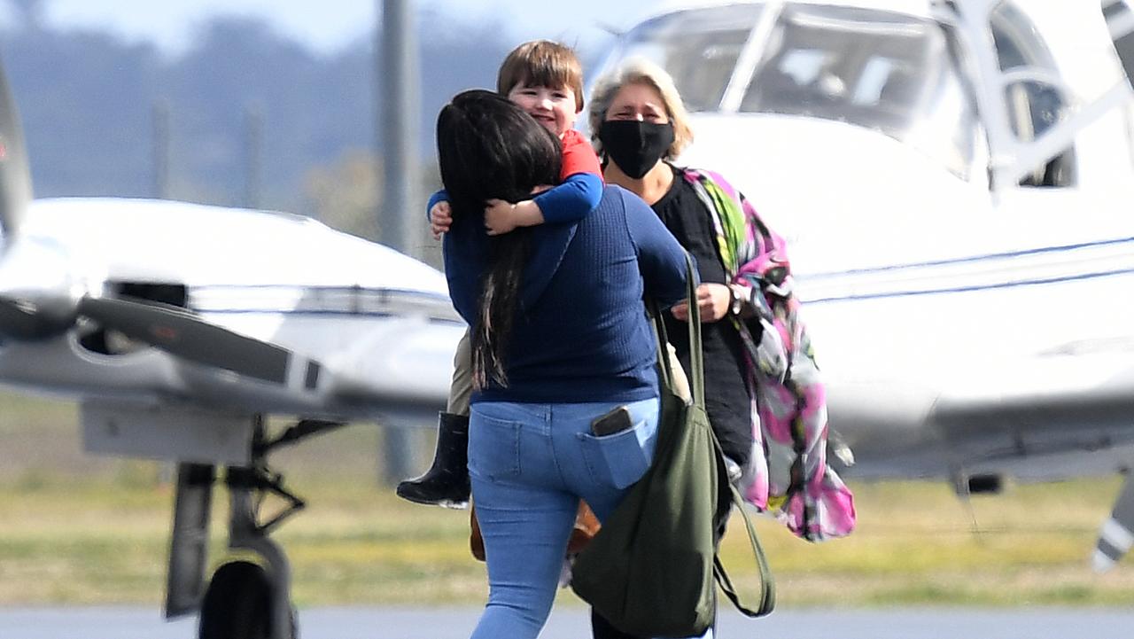 Mum and son have an emotional embrace on the tarmac. Photo: Dan Peled