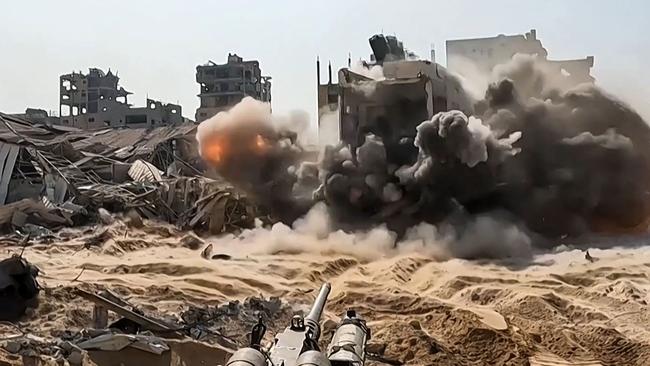 An Israeli gun firing at a building inside the Gaza Strip. Picture: AFP