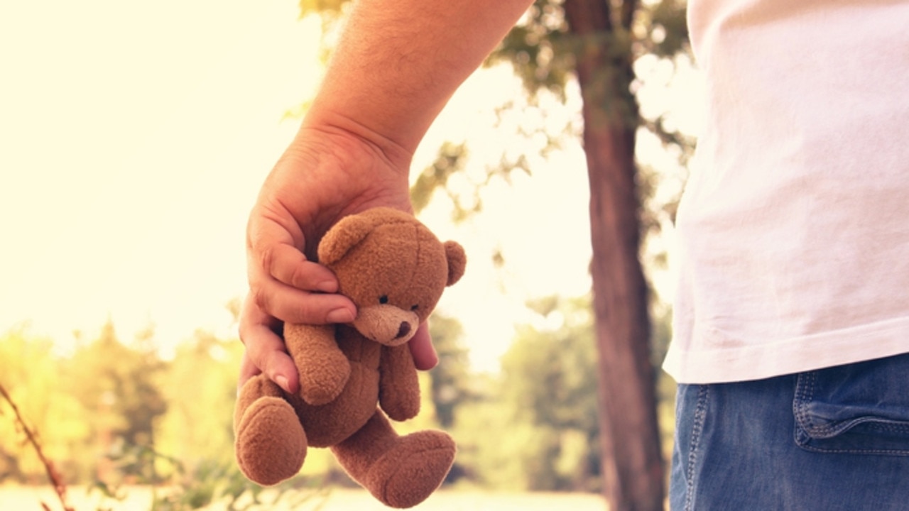 Man holding a teddy bear. Photo: iStock