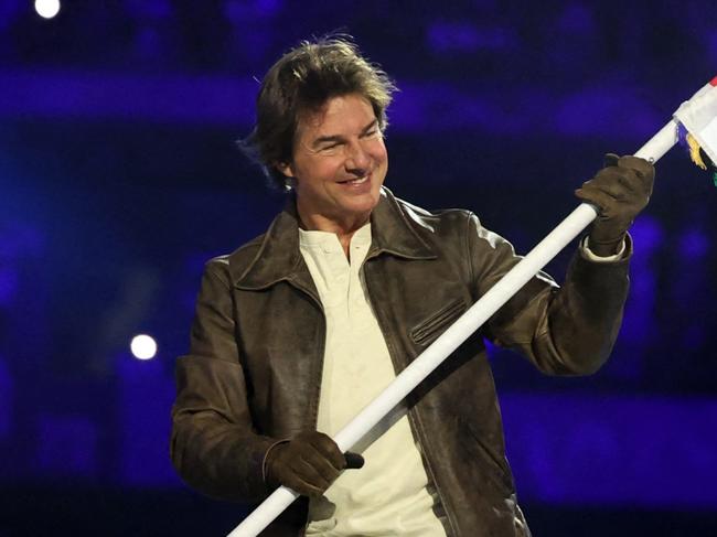 PARIS, FRANCE - AUGUST 11: Actor Tom Cruise holds the Olympic flag during the Closing Ceremony of the Olympic Games Paris 2024  at Stade de France on August 11, 2024 in Paris, France. (Photo by Fabrizio Bensch- Pool/Getty Images)