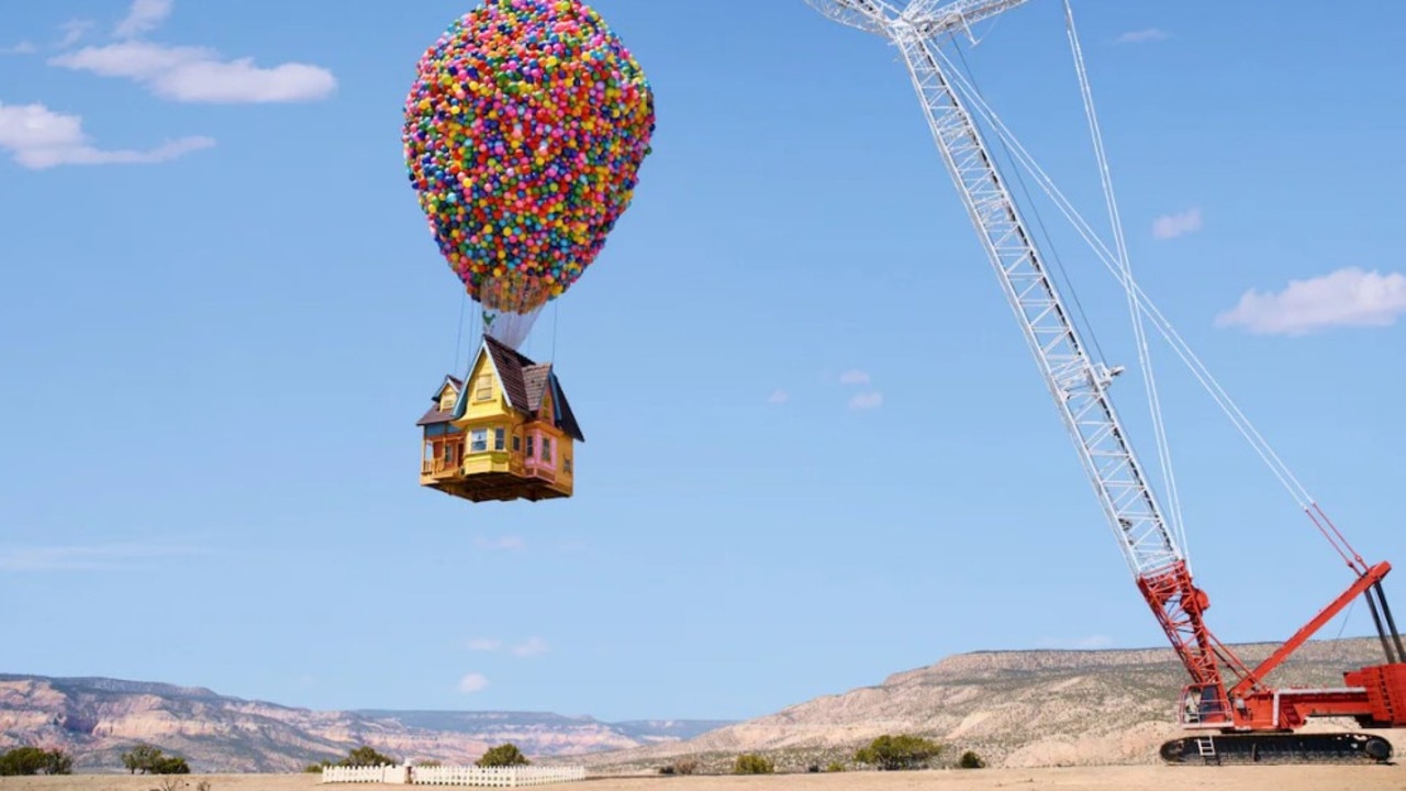 A huge crane holds the airborne house high up off the ground. Picture: supplied/Airbnb