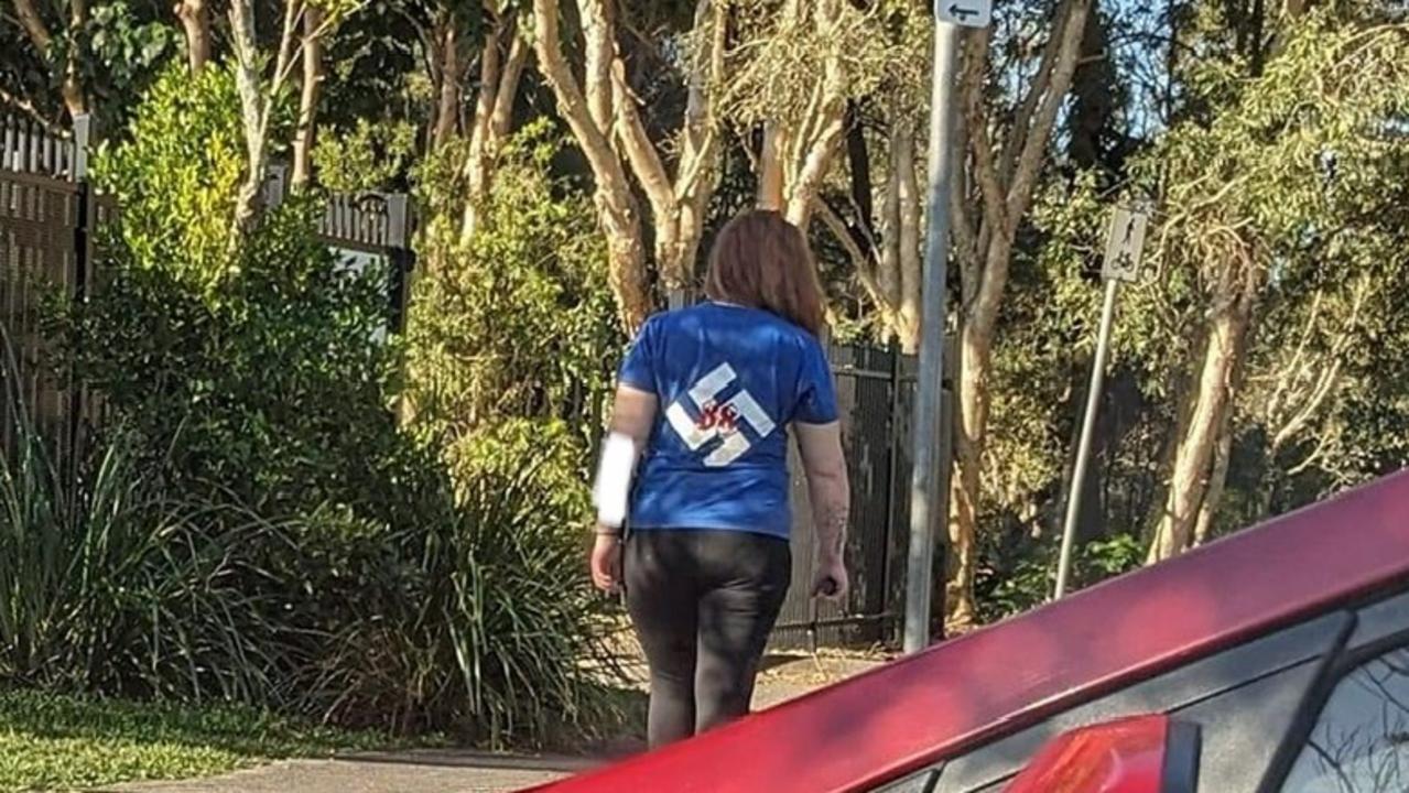 A picture of a woman outside a Sunshine Coast primary school wearing a shirt with a hate symbol on it has emerged. Photo: social media