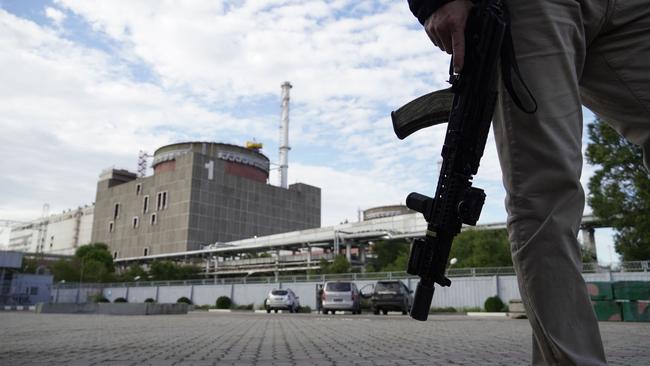 A security guard stands in front of the Zaporizhzhia Nuclear Power Plant in Enerhodar.