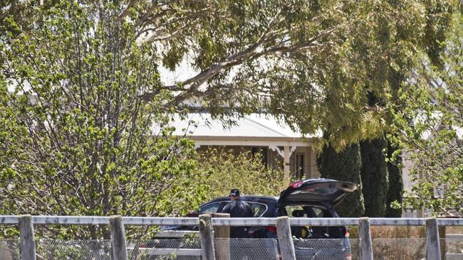 Police at the New England Highway property at Cambooya the day after a girl, 3, was found dead inside a home. Picture: Nev Madsen.