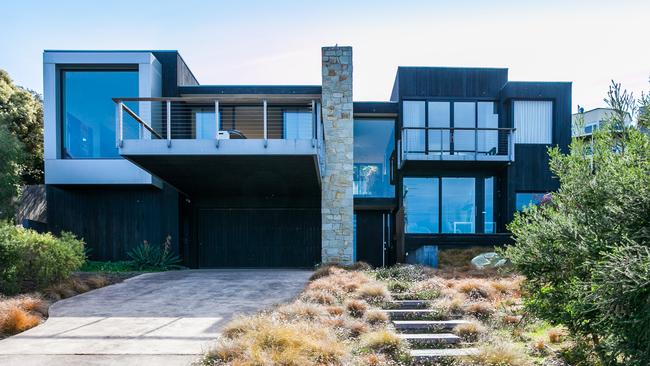 The sandstone wall defines 39 Hall St, Lorne.