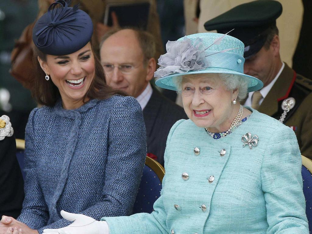 Kate Middleton laughs as Britain's Queen Elizabeth II gestures as they watch part of a children's sports event on their visit to Vernon Park in Nottingham in June 2012. Picture: Phil Noble/AFP