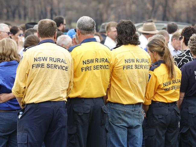 Members of the Rural Fire Service form a guard of honour at Patrick and Robert Salway’s funeral at Cobargo. Picture: AAP/Sean Davey