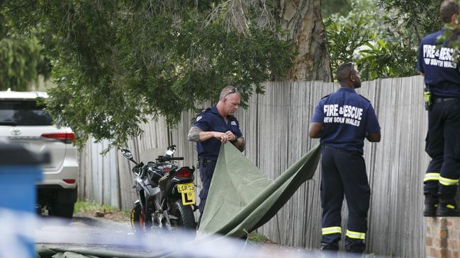 Emergency crews search a rear laneway yesterday. Picture: Tim Pascoe