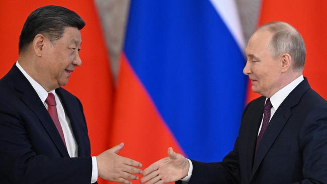 Russian President Vladimir Putin and his Chinese counterpart Xi Jinping shake hands at the end of a signing ceremony and the joint media statement following their talks at the Kremlin. Picture: AFP