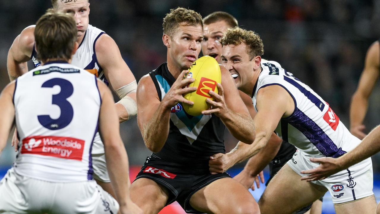 ADELAIDE, AUSTRALIA - APRIL 13: Dan Houston of the Power looks to handball during the round five AFL match between Port Adelaide Power and Fremantle Dockers at Adelaide Oval, on April 13, 2024, in Adelaide, Australia. (Photo by Mark Brake/Getty Images)