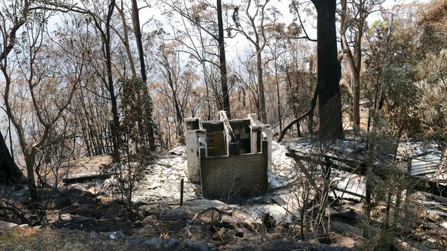 Charred ruins left behind after last year’s bushfire at Binna Burra. Picture: Nigel Hallett