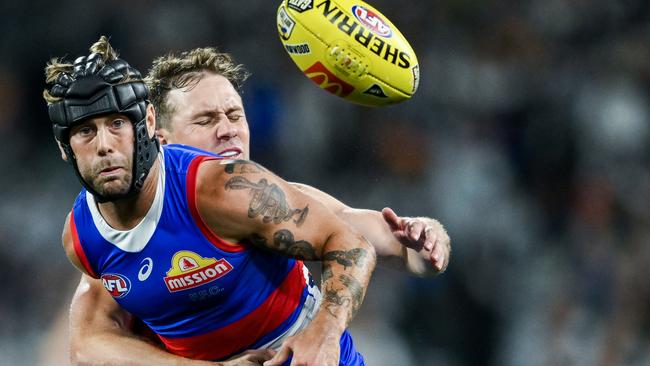 ADELAIDE, AUSTRALIA - APRIL 06:  Caleb Daniel of the Bulldogs  competes with  Mitch Duncan of the Cats during the round four AFL match between Western Bulldogs and Geelong Cats at Adelaide Oval, on April 06, 2024, in Adelaide, Australia. (Photo by Mark Brake/Getty Images)