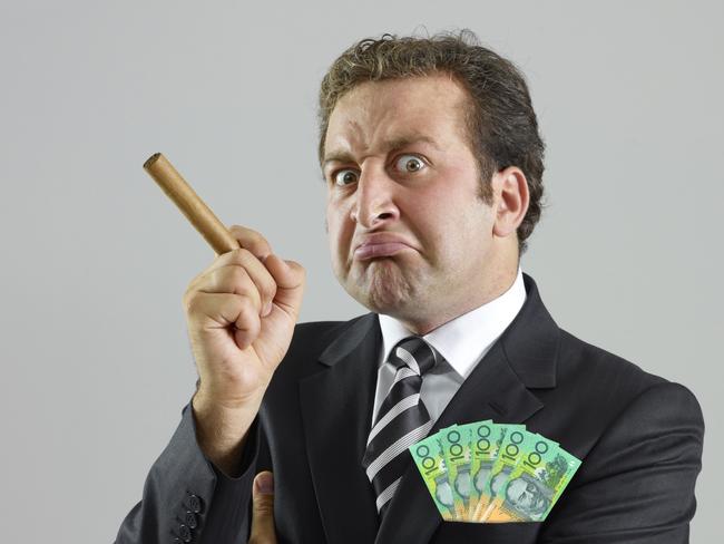 A greedy bank smoking a cigar and with cash in his suit pocket. Picture: iStock.