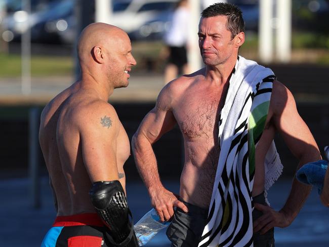 Hugh Jackman chats with Paul de Gelder after a quick dip at Bondi Beach. Picture: Getty