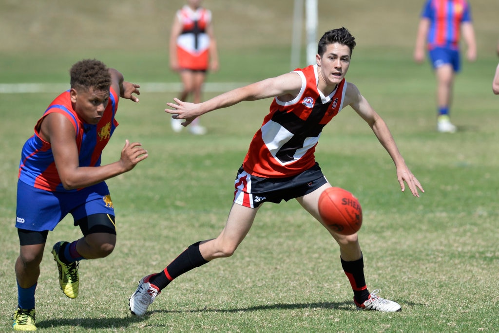 Doug Collins (left) for Downlands College and Pat Sankey for Our Lady of the Southern Cross College compete for possession in AFL Queensland Schools Cup Darling Downs round at Captain Cook ovals, Friday, April 27, 2018. Picture: Kevin Farmer