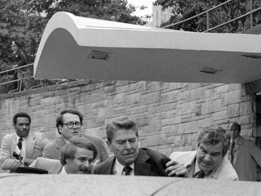 US President Ronald Reagan was rushed into the presidential limousine by Secret Service agents after being shot in the assassination attempt.