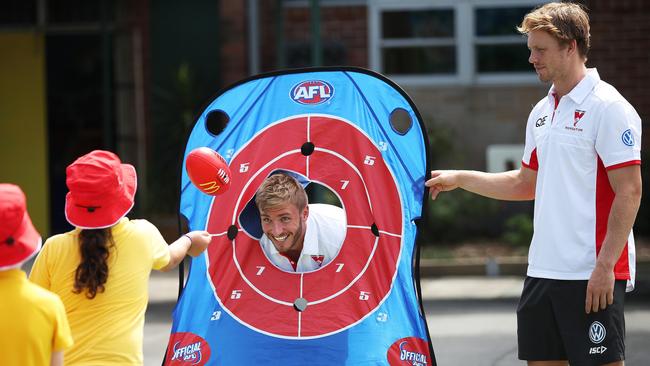 Sydney Swans players Kieren Jack and Callum Mills at a Swansfit coaching clinic at Chifley Public School in Malabar. Picture: Phil Hillyard