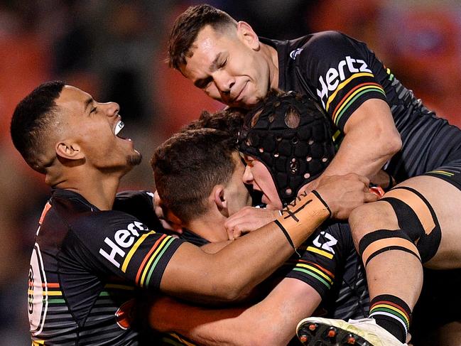 Nathan Cleary of the Panthers (centre) celebrates with teammates after scoring a try during the Round 21 NRL match between the Penrith Panthers and the Cronulla Sharks at Panthers Stadium in Sydney, Friday, August 9, 2019. (AAP Image/Dan Himbrechts) NO ARCHIVING, EDITORIAL USE ONLY