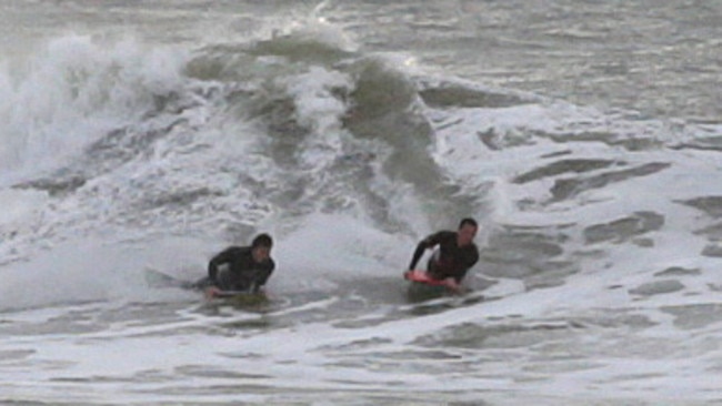 Surfers out in the dangerous, choppy conditions at Terrigal this morning. Picture: Mark Scott