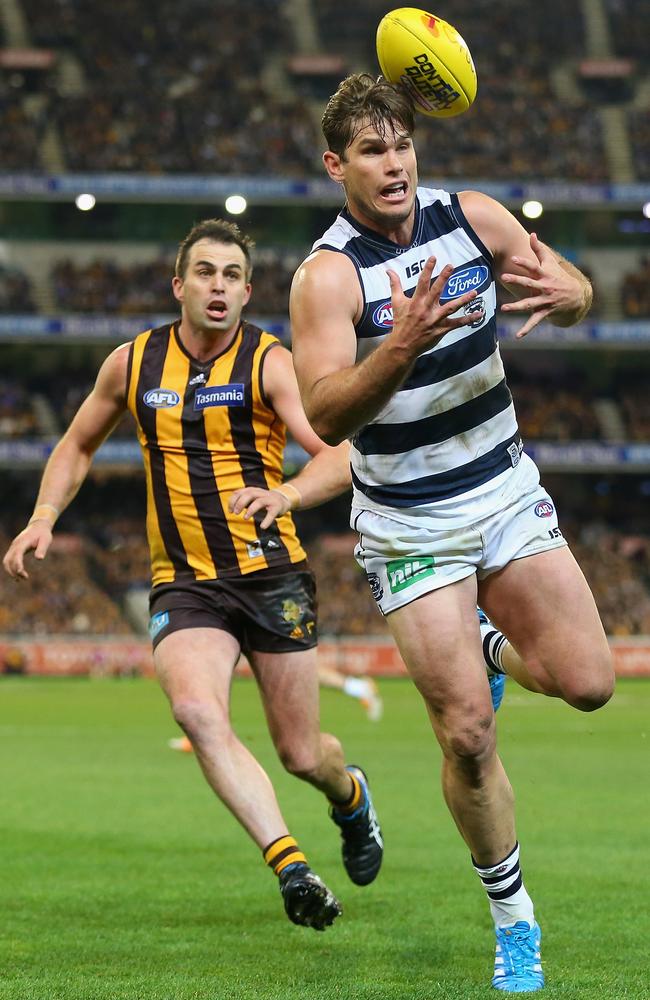 Cat Tom Hawkins fumbles a mark in front of Hawk Brian Lake. Picture: Getty