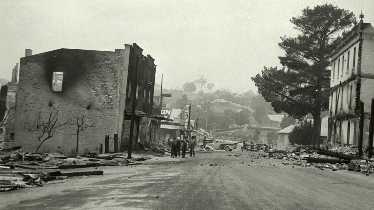 Residents survey what was left of the Victorian town of Omeo after the fire swept through. 