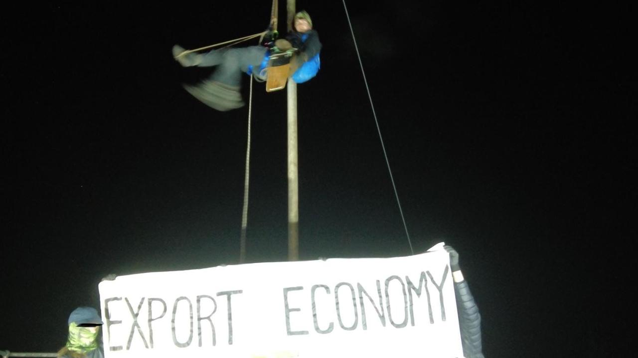 Protesters at the Newcastle coal port displayed a banner with the words “Export economy = Climate f**kery” during their protest action. Picture: Blockade Australia