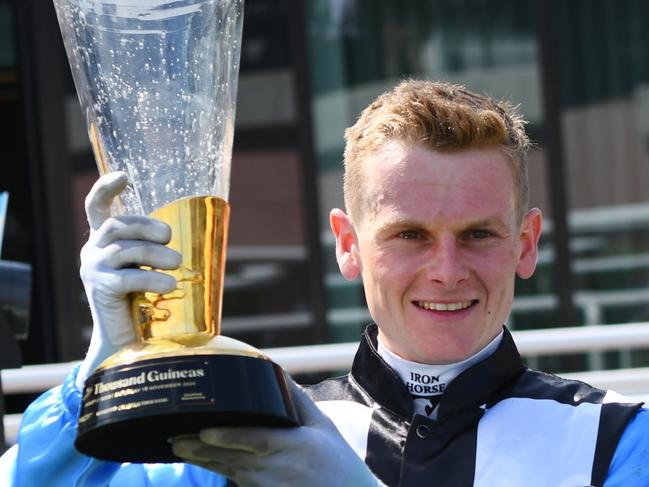 MELBOURNE, AUSTRALIA - NOVEMBER 16: Ethan Brown poses with trophy after riding Another Prophet to win Race 7, the Schweppes Thousand Guineas during Melbourne Racing at Caulfield Racecourse on November 16, 2024 in Melbourne, Australia. (Photo by Vince Caligiuri/Getty Images)