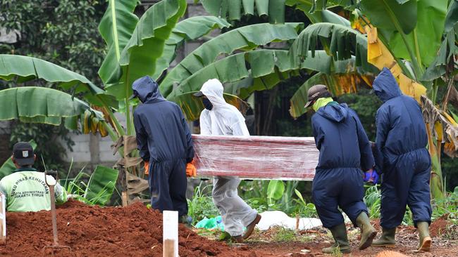 A COVID-19 victim is buried at Jakarta’s Pondok Ranggon cemetery last May. Picture: AFP