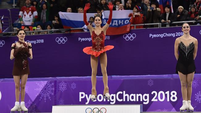 Gold medallist Alina Zagitova (centre) celebrates with (left) silver medallist Evgenia Medvedeva and bronze medallist Canada's Kaetlyn Osmond. Photo: AFP