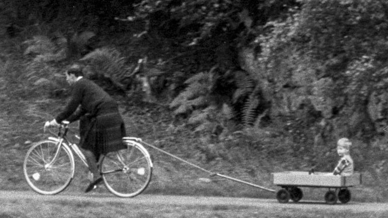 Prince Charles tows Prince Harry in a homemade cart during their summer break in 1988. Picture: Julian Parker/UK Press via Getty Images