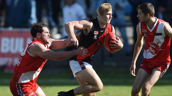 Frankston Bombers’ Alex Harnett tries to evade a tackle during last season’s MPFNL grand final. Picture: Chris Eastman.