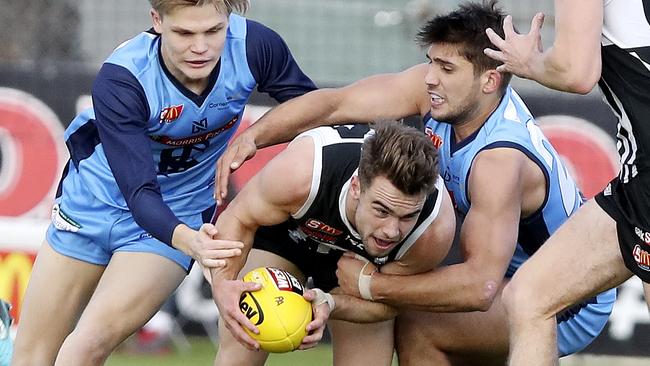 Port’s Will Snelling under pressure from Sturt’s Steven Slimming and James Battersby.