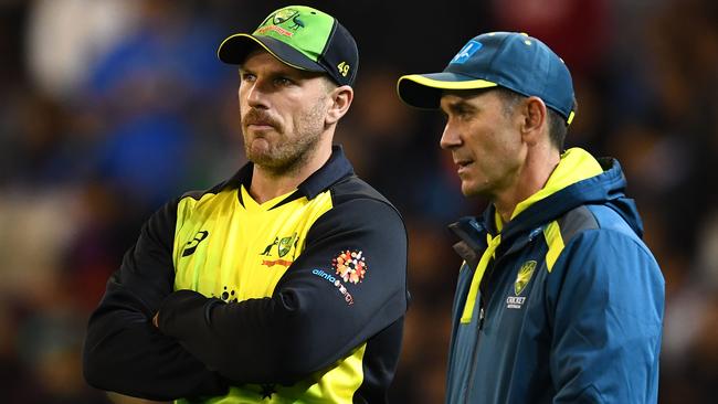 Aaron Finch speaks to Justin Langer after a T20 match against India.