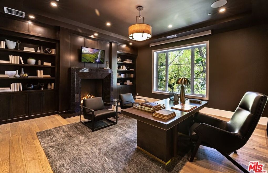 The wood-panelled office with built-in bookshelves and fireplace. Picture: Realtor