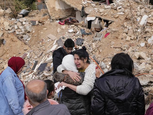 Displaced residents hug as they stand in front of the rubble of their destroyed house in Baalbek, eastern Lebanon. Picture: AP