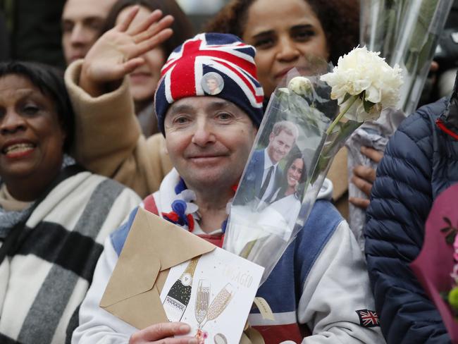 Royal fans await the arrival of Britain's Prince Harry and his fiancee Meghan Markle. Picture: AP Photo/Frank Augstein.