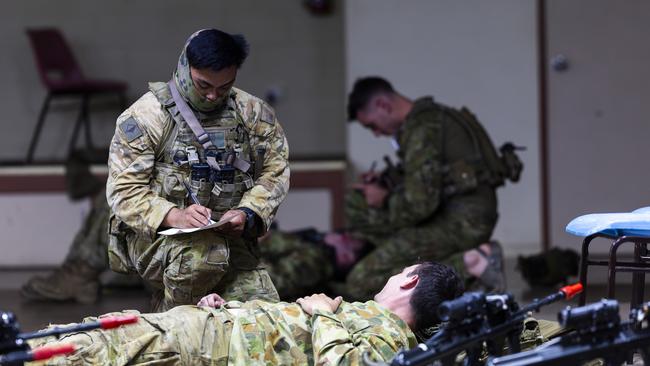 North Queensland Warfighter multi-nation military exercises in the Ingham region. An Australian Army soldier treats a simulated combat casualty during the North Queensland Warfighter Exercise in Ingham, Queensland. Picture: Supplied