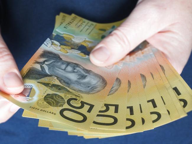 POV (Point of view) of young adult Australian woman counting cash of Australian dollar banknotes close up.