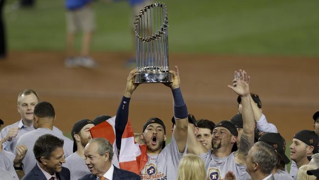 The Houston Astros celebrate with the trophy after their win against the Los Angeles Dodgers in Game 7 of baseball’s World Series