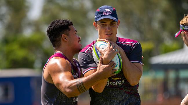 Queensland Reds winger Jock Campbell is tackled by Hunter Paisami during training in Johannesburg. Picture: QRU / Tom Mitchell