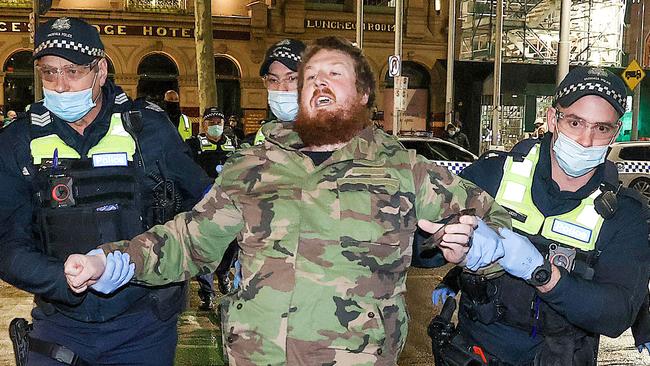 A Covid-19 anti-lockdown protestor is lead away. Picture : Ian Currie