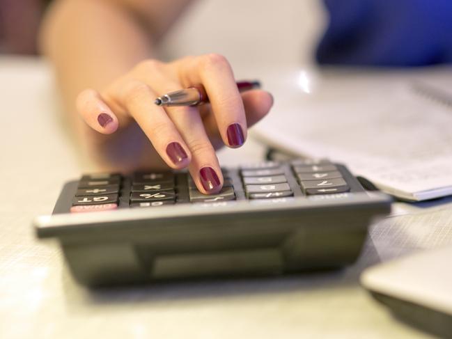 Close up of female accountant or banker making calculations