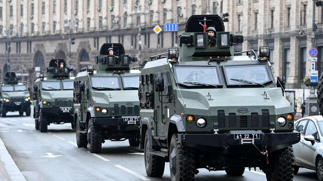 Ukrainian military vehicles move past Independence square in central Kyiv on February 24. Picture: AFP