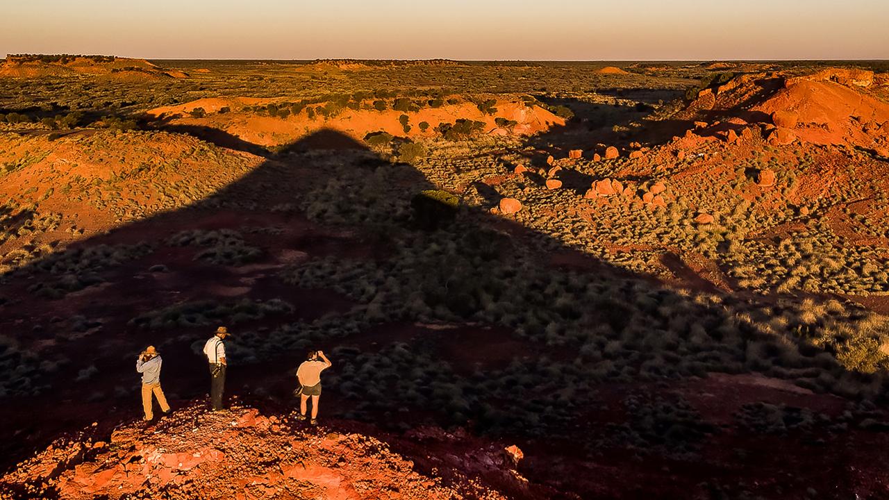 Outback in Focus photography competition finalist. Phd researchers Al Healy (L), Nick Leseberg (M) and voluntary research assistant Patrick Webster (R) surveying Pullen Pullen Night Parrot Reserve, in west Queensland. Photographed by Lachlan Gardiner.